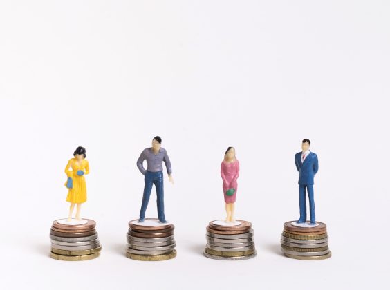 business-man-woman-sitting-equal-piles-coins